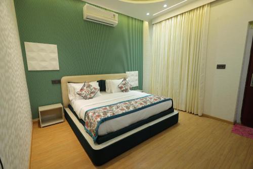 a bedroom with a bed in a green wall at Aquaa Villa 