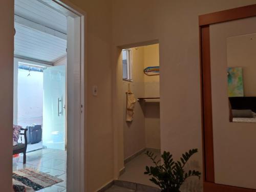a hallway with a door leading into a room at Colonial House in Porto Seguro