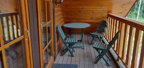 a patio with two chairs and a table on a deck at Mere Holiday Home in Yarve-Keskranna