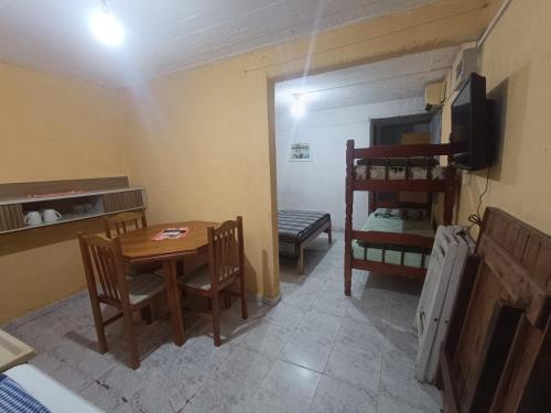 a small room with a table and chairs and a bunk bed at Apartamentos Laguna Merin Rincón del Lago in Lago Merin