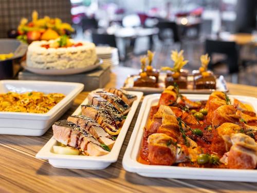 a buffet with plates of food on a table at Novotel Edinburgh Centre in Edinburgh