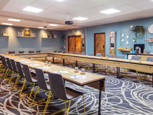 a large conference room with a long table and chairs at Novotel Edinburgh Centre in Edinburgh