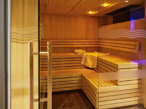a sauna with wood paneling and a glass door at Novotel Edinburgh Centre in Edinburgh