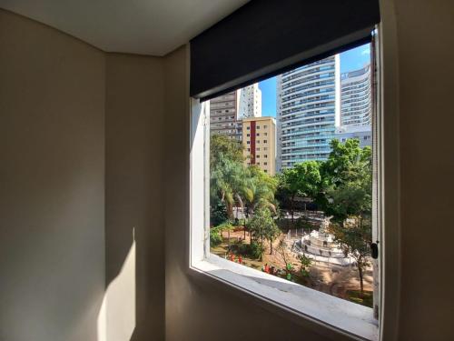 a window in a room with a view of a city at Flat - Apartium Palacete Victória in Sao Paulo
