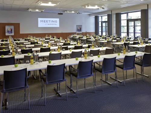 a large room with tables and chairs in it at Novotel München City in Munich