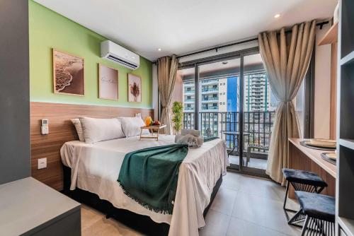 a bedroom with a bed and a balcony at Lumen in Sao Paulo