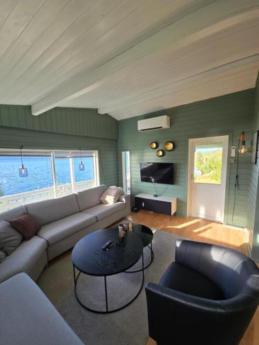 a living room with a couch and a table at Lyngenfjord view in Engnes