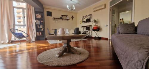 a living room with a table and a couch at Vista triangular in Las Palmas de Gran Canaria