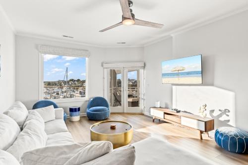 a white living room with a white couch and blue chairs at New Listing! Moorings 510 - Yacht View Serenity! in Isle of Palms