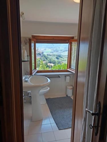a bathroom with a sink and a window at Casa Il Tramonto Sunset house in Gualdo Cattaneo