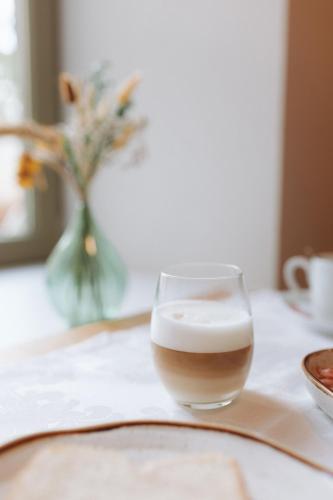 a glass of coffee sitting on top of a table at Casa da Fonte de Cima in Celorico de Basto