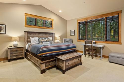 a bedroom with a bed and a desk and a chair at Whispering Pines Escape in Suncadia- Hot Tub, BBQ, Firepit, Fully Equipped Kitchen, Smart TVs, Hi-speed Wi-Fi in Roslyn