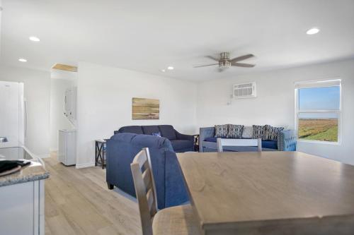 a living room with a couch and a table at Charming home with fantastic view in Bolivar Peninsula