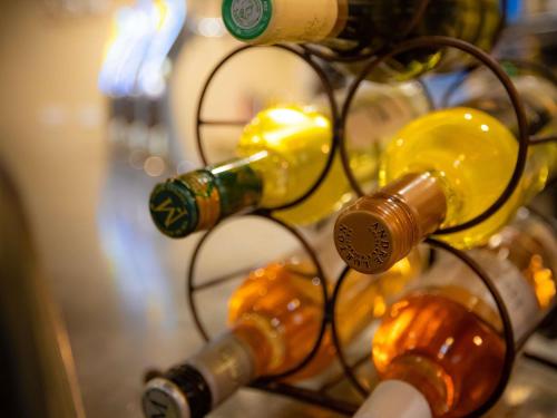 a bunch of wine bottles on a rack at ibis Besançon Centre la City in Besançon