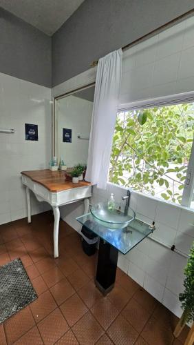 a bathroom with a sink and a mirror at Hostel Auikyani in Cozumel