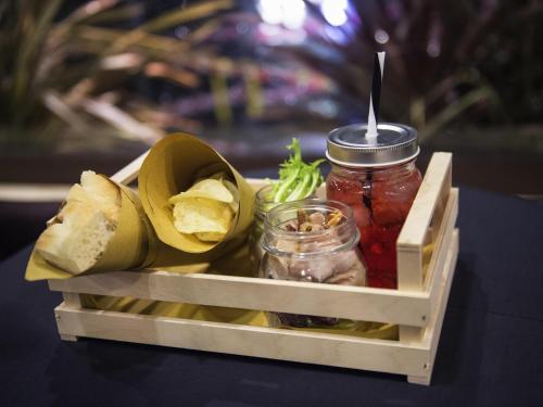 a wooden crate with jars of pickles and fruit at Mercure Roma Piazza Bologna in Rome