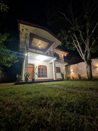 a house at night with the lights on at Sea Breeze Rest in Talalla