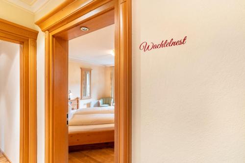 a door to a bedroom with a bed in a room at Wein- und Klimahotel Bergfriedel in Bühlertal