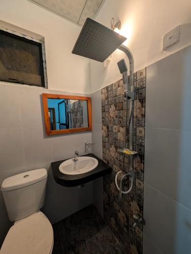 a bathroom with a toilet and a sink at Sea Breeze Rest in Talalla