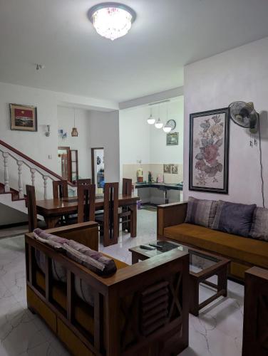 a living room with couches and tables at Sea Breeze Rest in Talalla