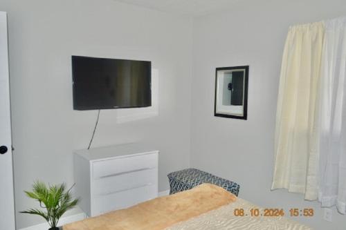 a living room with a tv on a white wall at Fully Furnished Home in St Cloud in Saint Cloud