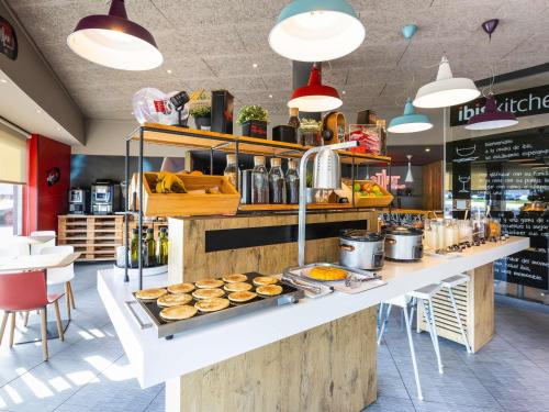 a bakery with a counter with pastries on it at Ibis Bilbao Barakaldo in Barakaldo