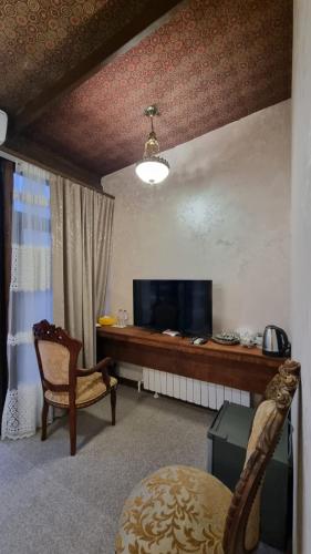a living room with a television and a chair at Grandview Boutique Hotel in Baku