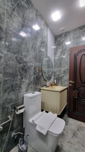 a bathroom with a toilet and a sink and a mirror at Grandview Boutique Hotel in Baku