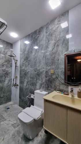 a bathroom with a toilet and a sink and a tub at Grandview Boutique Hotel in Baku