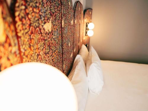 a close up of a blanket on a bed at Ibis Styles Madrid Centro Maravillas in Madrid