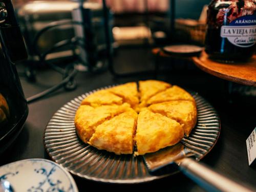 a pie sitting on a plate on a table at Ibis Styles Madrid Centro Maravillas in Madrid