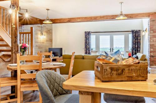 a living room with a couch and a table at Abbots Barn in Upwell