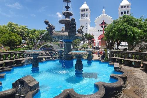 a fountain in a park in front of a building at Ana's Place in Santa Ana