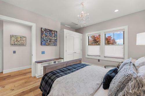 a bedroom with a bed and two windows at Mountain-View Retreat with Hot Tub & Waterfalls in Cascade Locks