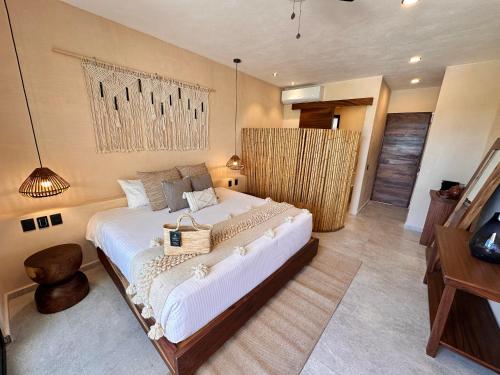 a bedroom with a large bed in a room at Ana y Jose Hotel & Beach Club Holbox in Holbox Island