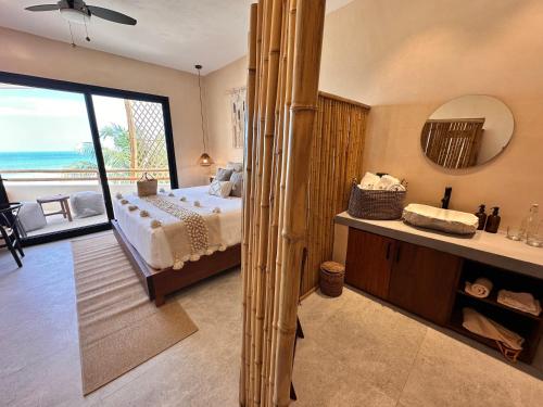 a bedroom with a bed and a view of the ocean at Ana y Jose Hotel & Beach Club Holbox in Holbox Island