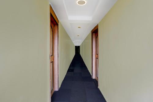 a hallway with a stairway in a building at Hotel O Diana Palace Lodging & Boarding in Mumbai