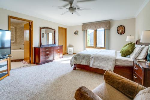 a bedroom with a large bed and a television at Private Yard with Patio Family Getaway in Macomb in Waldenburg