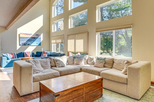 a living room with two couches and a table at Hot Tub and Game Room Spacious Whitehall Home! in Whitehall