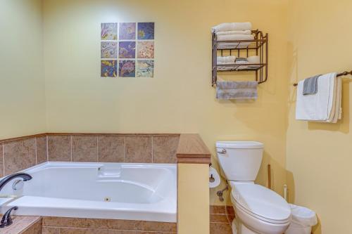a bathroom with a white tub and a toilet at Hot Tub and Game Room Spacious Whitehall Home! in Whitehall