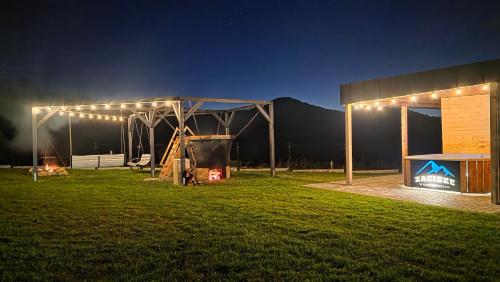 a tent with lights in a field at night at Zacisze w Karkonoszach in Karpacz