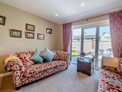 a living room with a couch and a window at 4 Bed in Saint Asaph 96246 in St Asaph