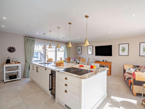 a kitchen and living room with a counter and a couch at 4 Bed in Saint Asaph 96246 in St Asaph