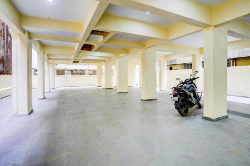 a motorcycle parked in an empty parking lot at Super Collection O Kalamboli New Panvel Formerly Golden Paradise in Kalamboli