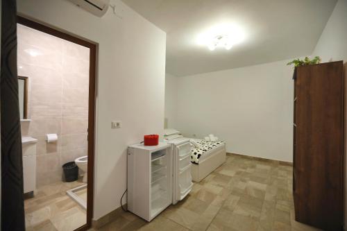 a bathroom with a toilet and a sink and a mirror at Casa Selina in Corbu