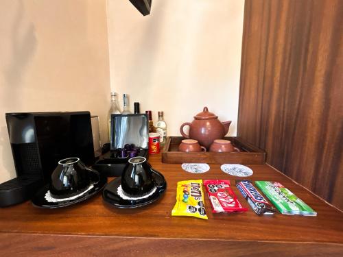 a wooden counter top with a coffee maker and snacks at Ana y Jose Hotel & Beach Club Holbox in Holbox Island