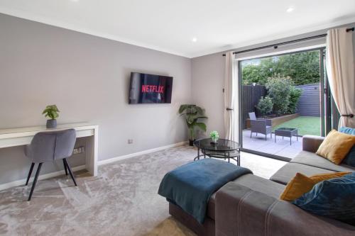 a living room with a couch and a table at Spotless Two-Bedroom Home with Garden and Parking in Stevenage