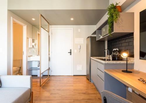 a kitchen and living room with a counter top at Charlie Aeroporto Congonhas CGH in Sao Paulo