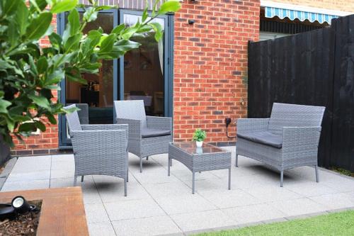 a group of chairs and a table on a patio at Spotless Two-Bedroom Home with Garden and Parking in Stevenage