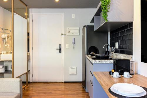 a kitchen with a sink and a counter top at Charlie Aeroporto Congonhas CGH in Sao Paulo